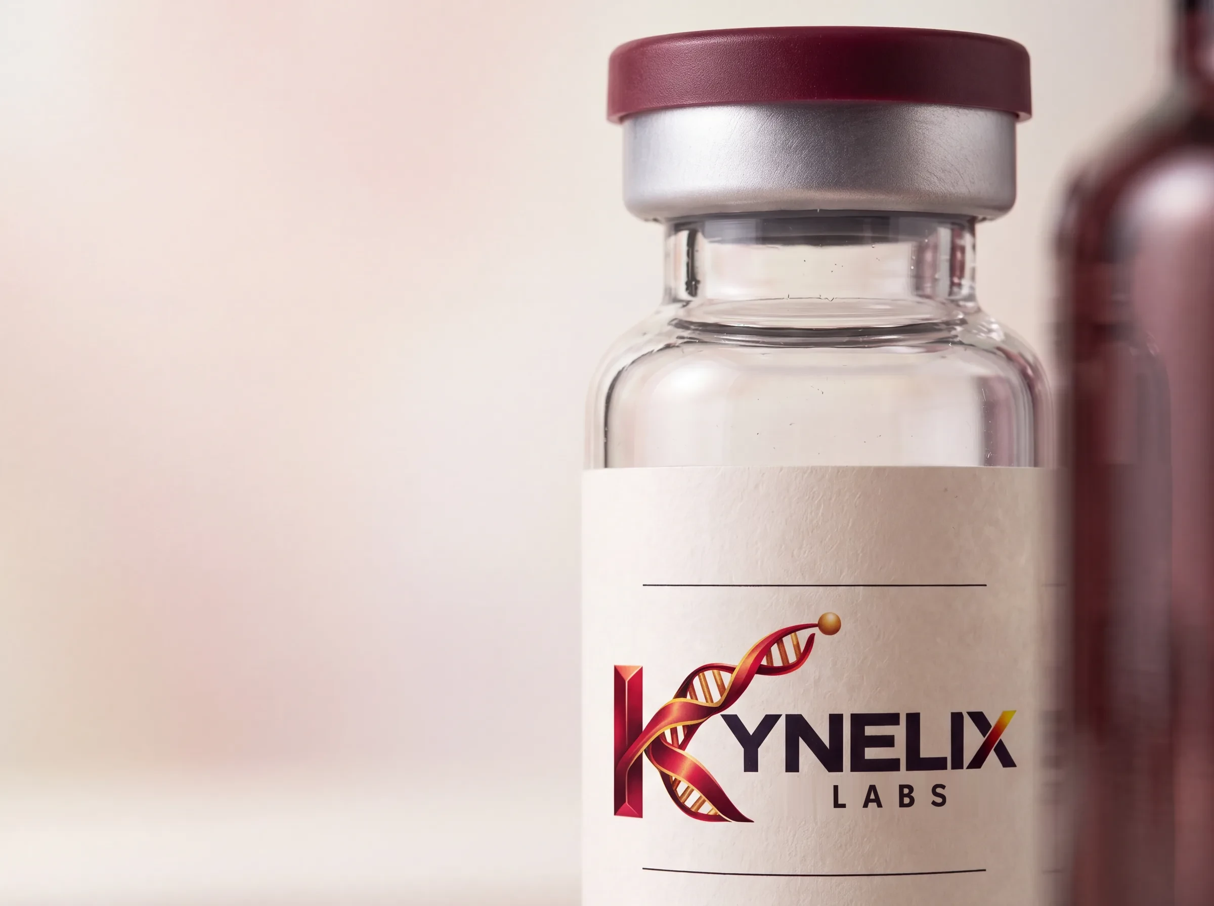 A close view of a Kynelix glass vial with its burgundy cap, silver crimp and label
